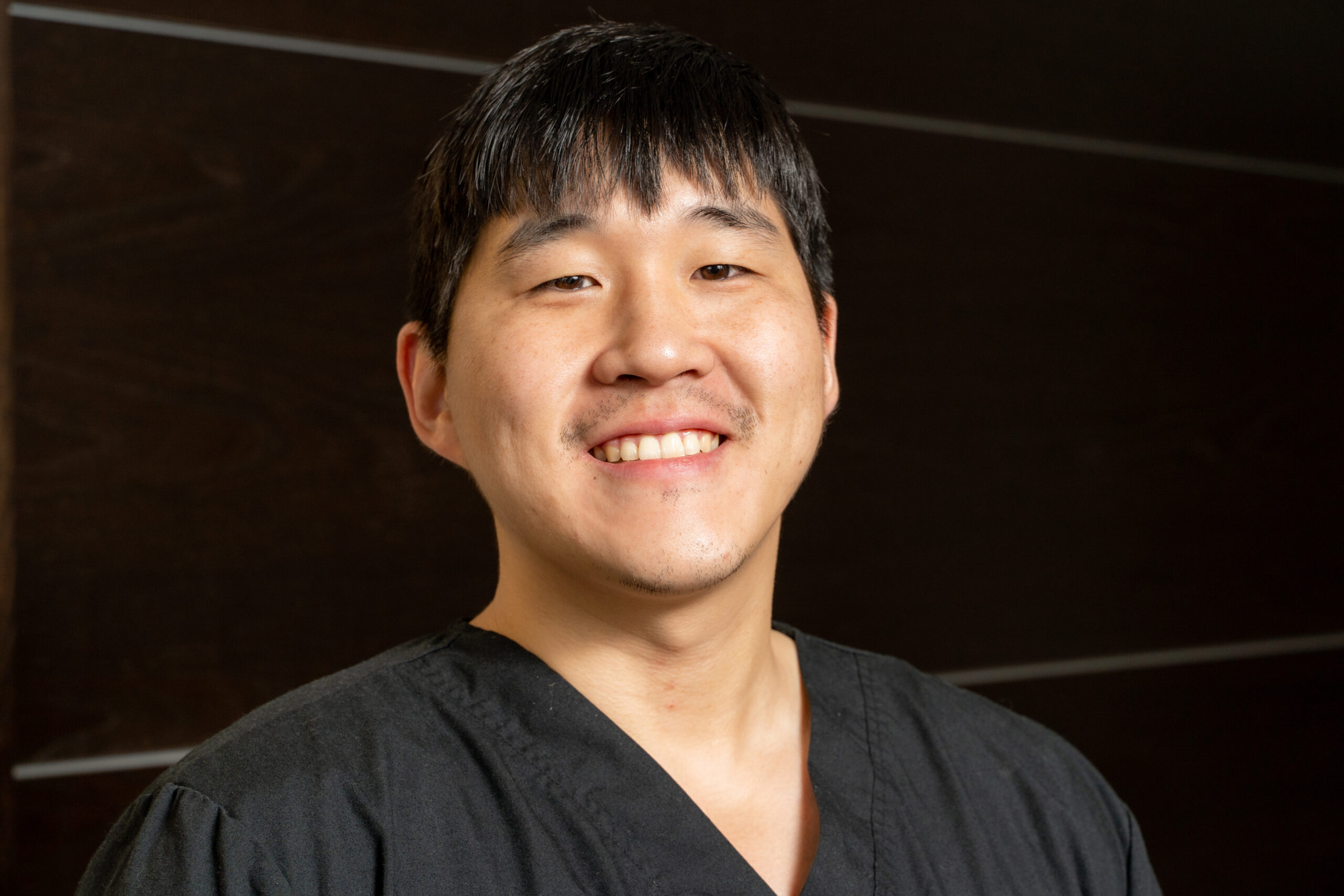 Dr. Kunmin Roo, experienced dentist with a friendly smile, providing exceptional dental care