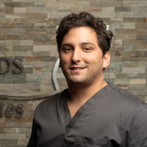 Dr. Eddie Gonzalez, professional dentist smiling in headshot
