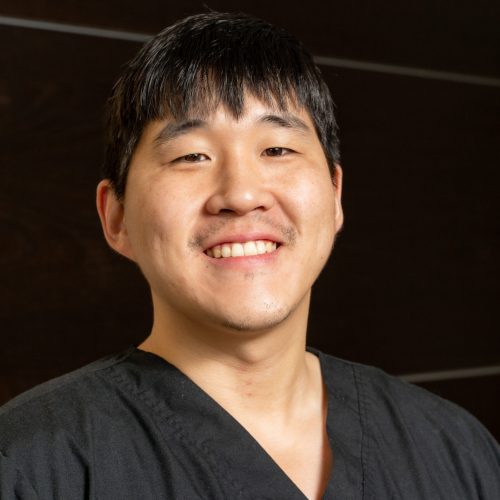 Dr. Kunmin Roo, experienced dentist with a friendly smile, providing exceptional dental care