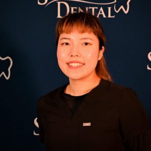 Smiling dentist, Dr. Sophie Kim, promoting oral health and beautiful smiles