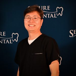 Professional headshot of Dr. Sangin Lim wearing glasses in front of blue backdrop