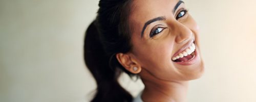 adult smiles after learning How to keep teeth clean with clear aligners