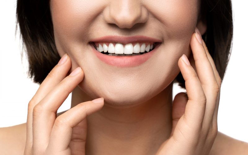 Closeup of beautiful female smile with a white teeth